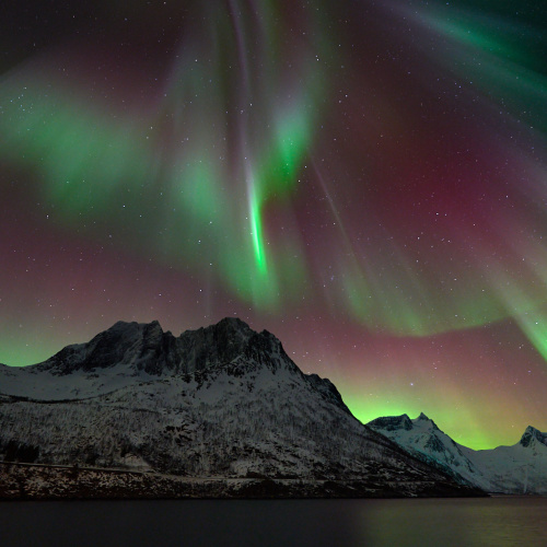 Red and green hues from the Northern Lights in Senja